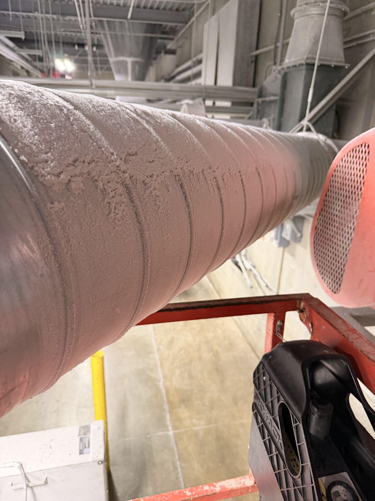Heavy combustible dust accumulation coating overhead ductwork before remediation
